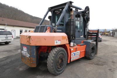 Forklift truck showing Toyota THD3000-24 with orange counterweights and black cab, side stickers, outdoor yard environment.