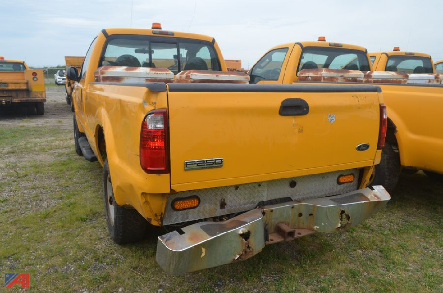 Rear view of a yellow 2009 Ford F-250 Super Duty dump truck showing tailgate, bumper, and 'F-250' badge.