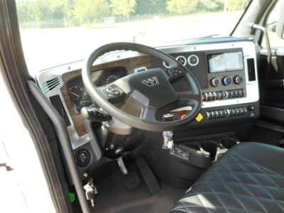Western Star 49X truck cab interior showing steering wheel, dashboard with gauges, infotainment screen, and control panel.