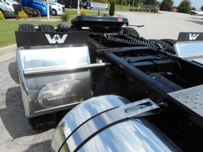 Semi truck chassis rear with Western Star branding, chrome fuel tanks, fifth wheel, and black frame showing cabless rear section.