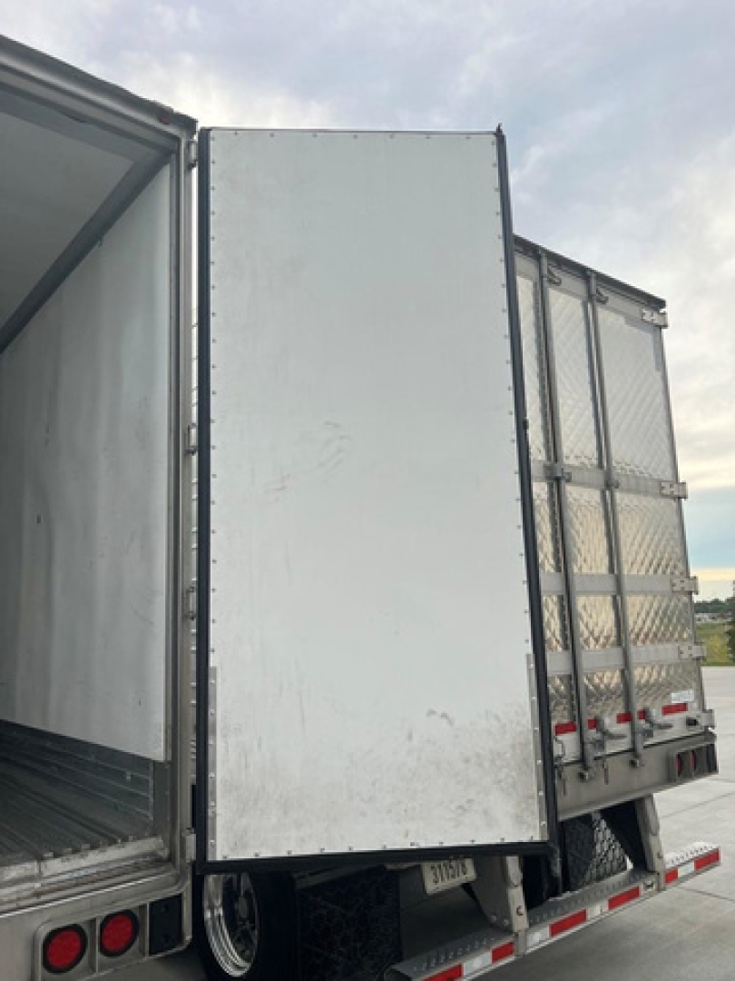 Reefer trailer rear and side door showing steel interior and metal panels with reflective tape