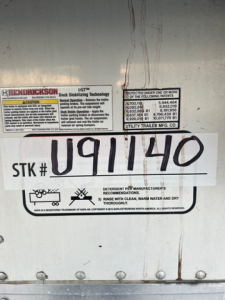 Trailer side showing stock number U91140 plate and labels on a refrigerated utility trailer.