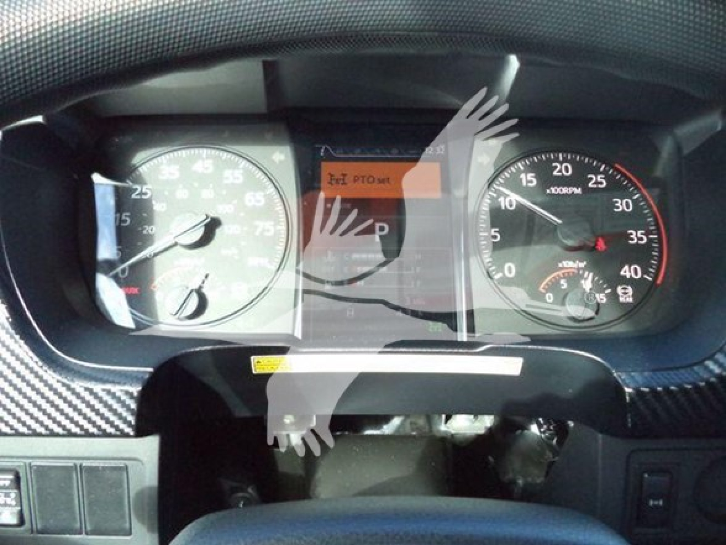 Dashboard view of a 2025 Hino 268A showing the instrument cluster with speedometer, tachometer, and a central display; no legible text other than standard gauge markings.
