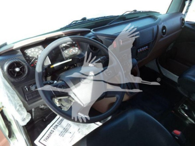 Interior of a 2025 Hino 268A cab showing steering wheel dashboard and driver seat with dashboard controls.