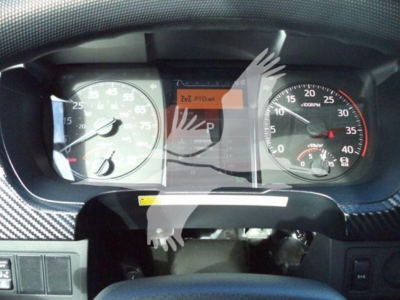 Dashboard view of a 2025 Hino 268A showing the instrument cluster with speedometer, tachometer, and a central display; no legible text other than standard gauge markings.