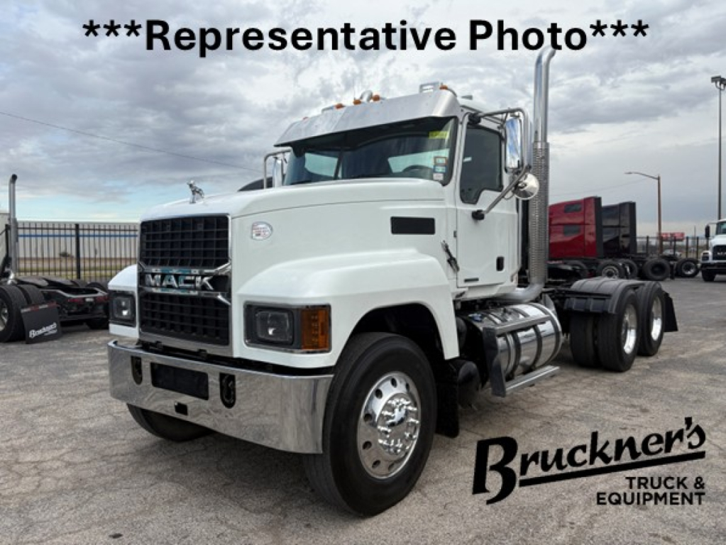 Mack PI64T tractor head with front grille and dual rear axles, white cab, chrome bumper, in-yard with Bruckner's watermark.