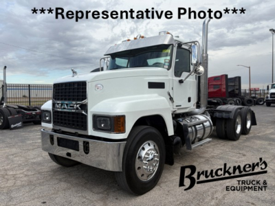 Mack PI64T tractor head with front grille and dual rear axles, white cab, chrome bumper, in-yard with Bruckner's watermark.