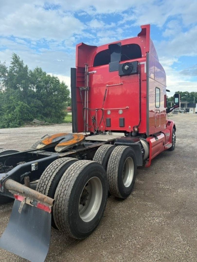 Peterbilt 579 tractor rear view showing sleeper cab, dual rear axles, and fifth wheel coupling.