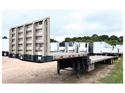 Great Dane drop deck trailer with aluminum and steel composite deck, viewed from side angle showing flatbed and ramp system.