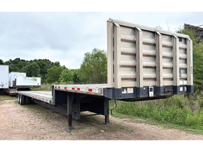 Great Dane drop deck trailer in field showing aluminum and steel composite bed and raised gooseneck with support legs visible.