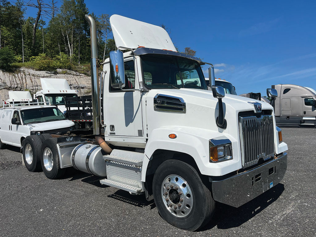 2017 Western Star 4700SF conventional daycab truck side/front view showing large chrome grille, hood, and sleeperless cab with chrome bumper and dual rear axles.