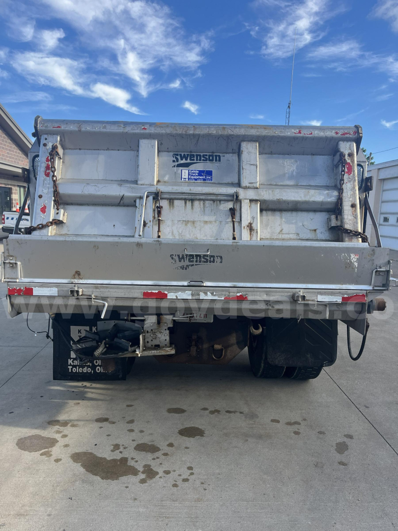 Rear view of a Swenson dump truck bed on a 2012 Hino 338 showing Swenson branding and hydraulic tailgate latches.
