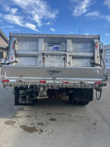 Rear view of a Swenson dump truck bed on a 2012 Hino 338 showing Swenson branding and hydraulic tailgate latches.