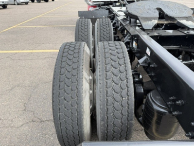 Kenworth T880 chassis with dual rear axles and tires visible, truck frame and fuel tank in view.