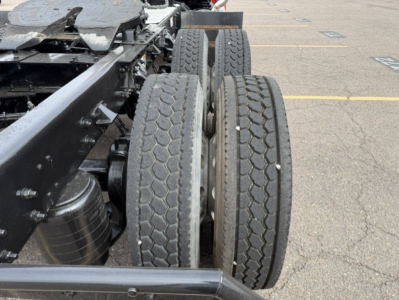 Kenworth T880 truck rear dual axle wheels and chassis with tires and suspension components visible.