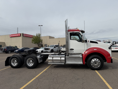 Kenworth T880 conventional daycab truck side view showing chassis and cab; wheels, fuel tanks, and exhaust stack visible.