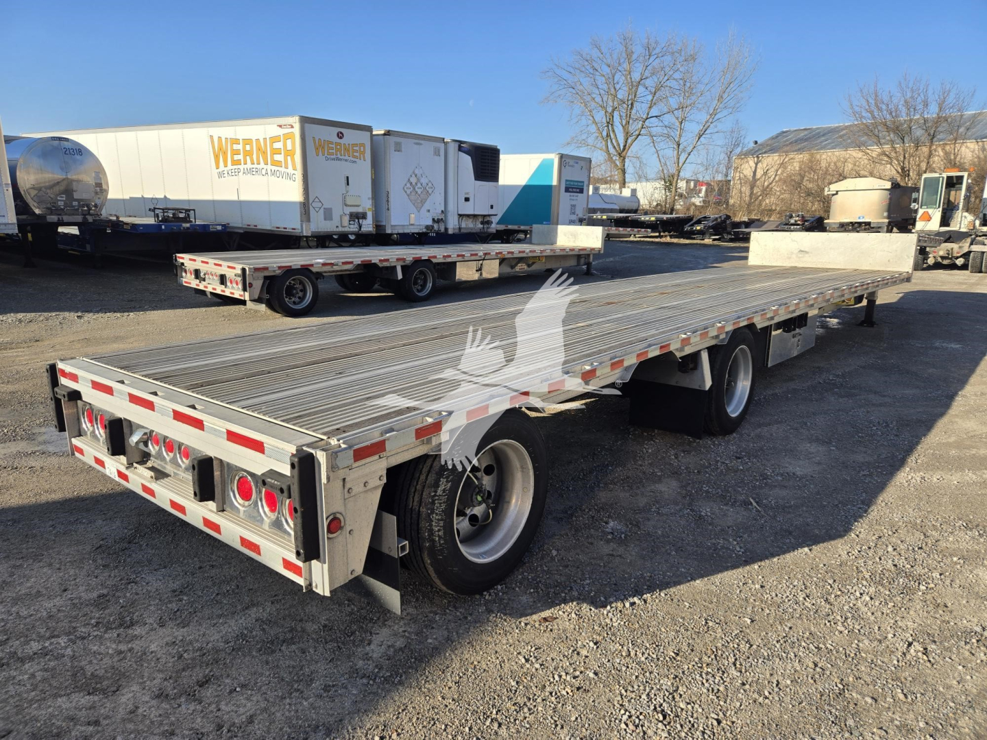 2019 Reitnouer Dropmiser trailer showing flatbed with dual rear axles and ramps.