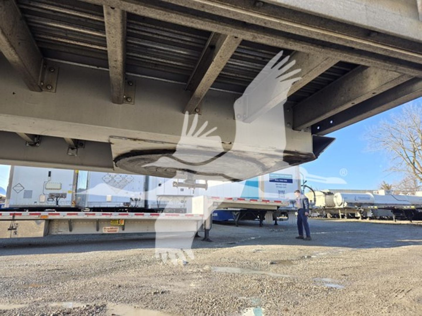 Trailer undercarriage showing drop deck mechanism and underside frame of a 2019 Reitnouer Dropmiser trailer.