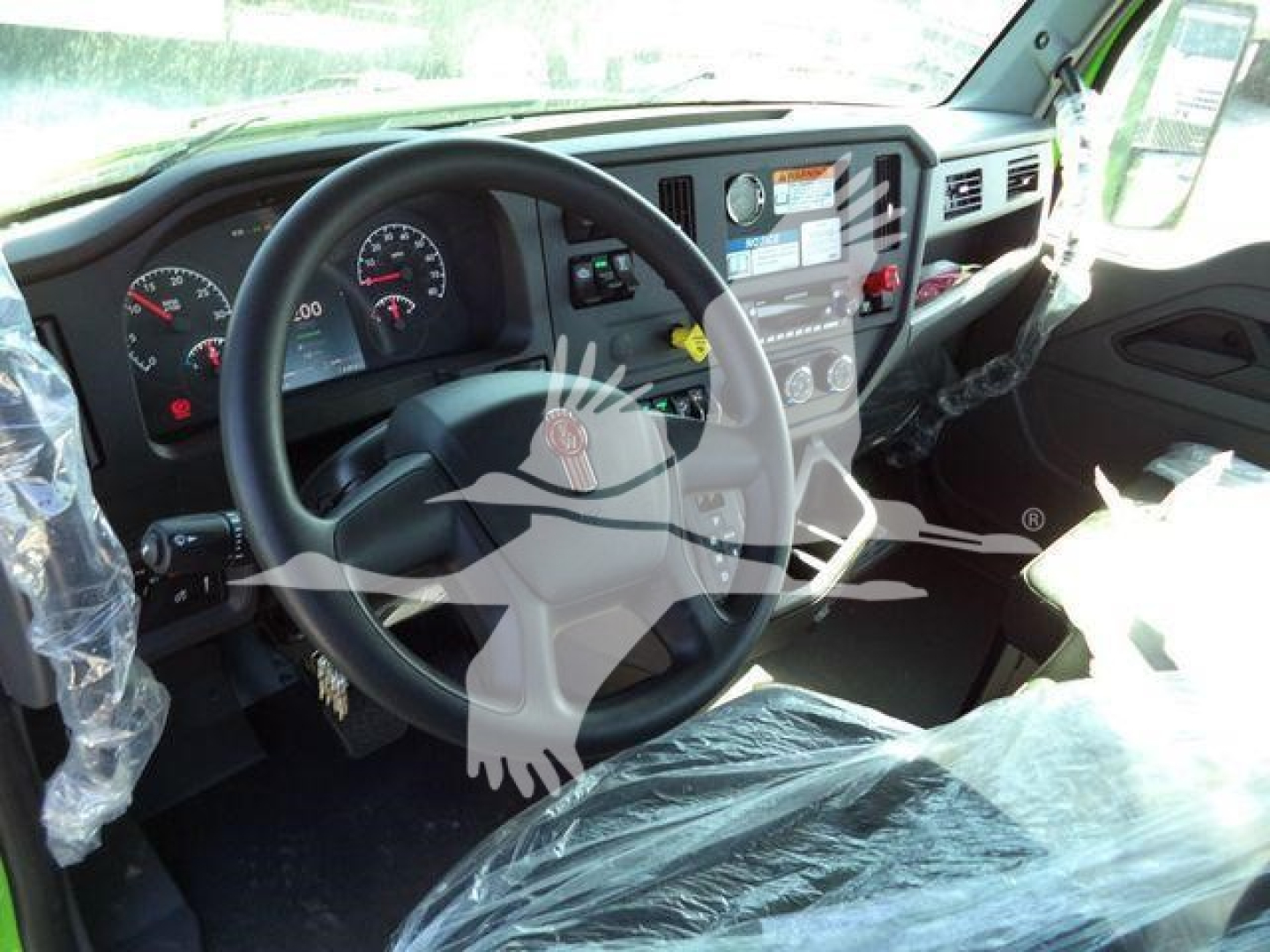 Kenworth truck cab interior showing steering wheel dashboard controls and center console of a new 2025 T280 rollback truck