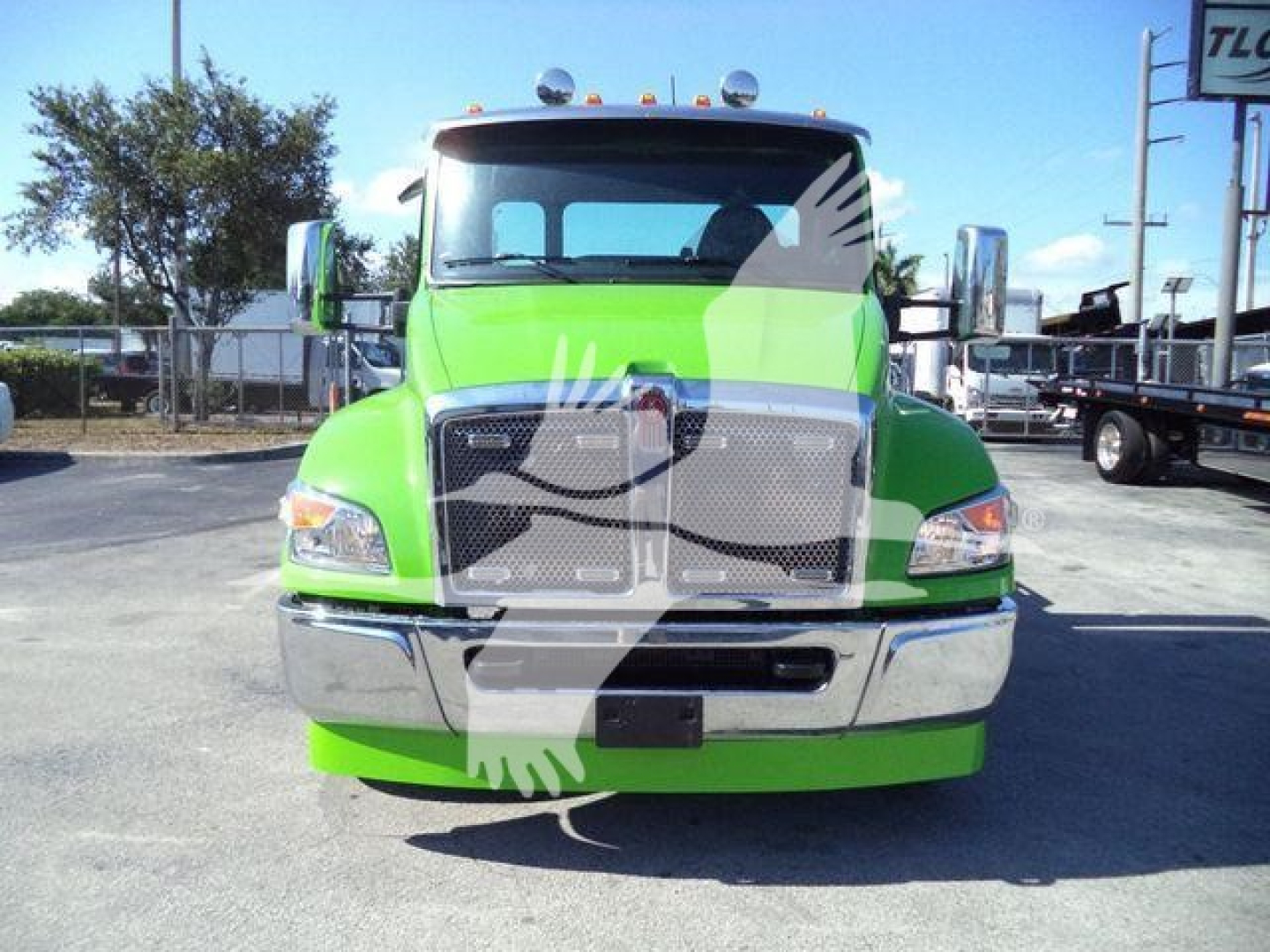 Kenworth T280 rollback truck front view, bright green cab with chrome bumper and grille, stock image overlapping watermark