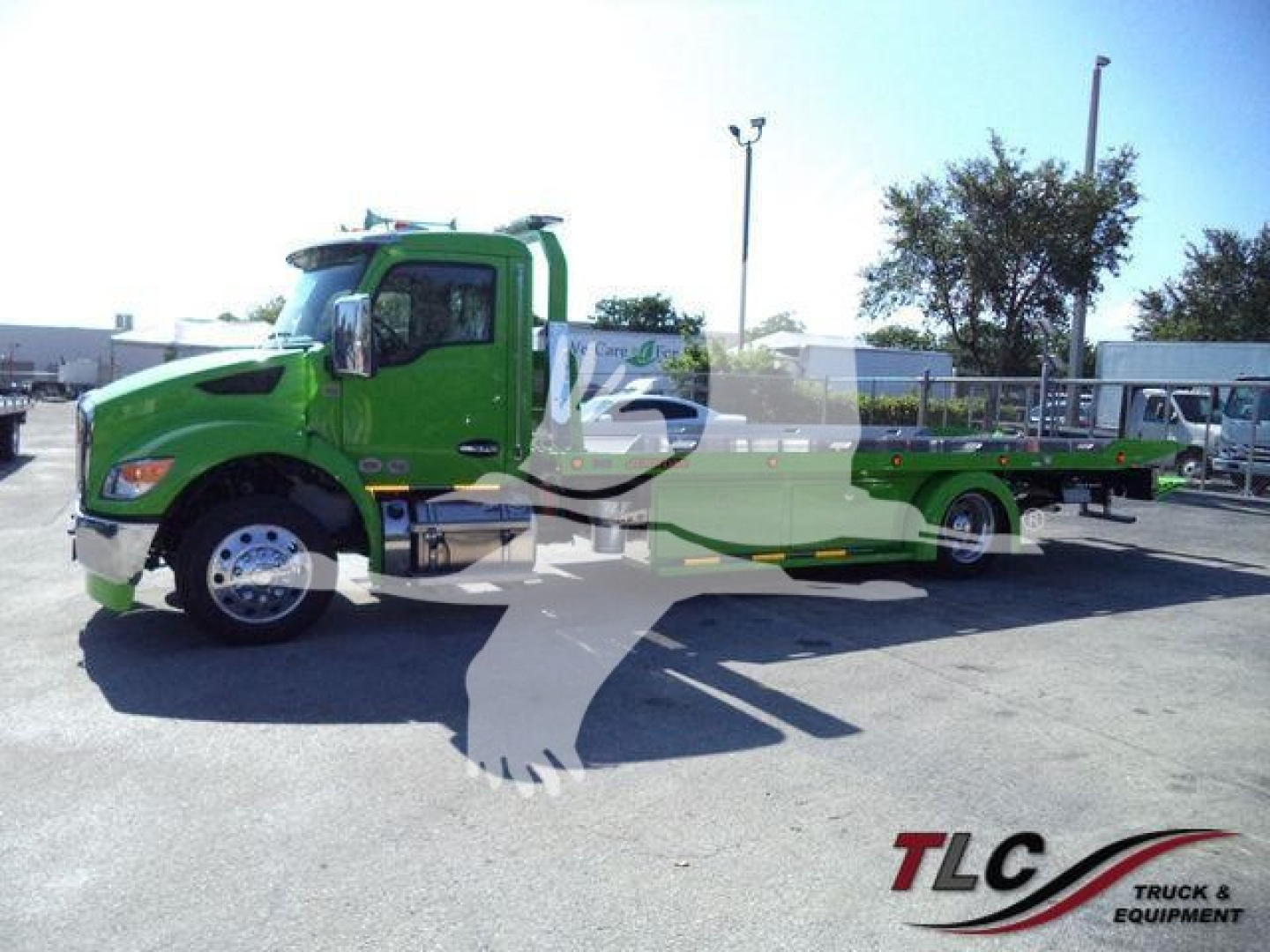 Kenworth T280 rollback tow truck profile in bright green with long flatbed, front cab view, company watermark