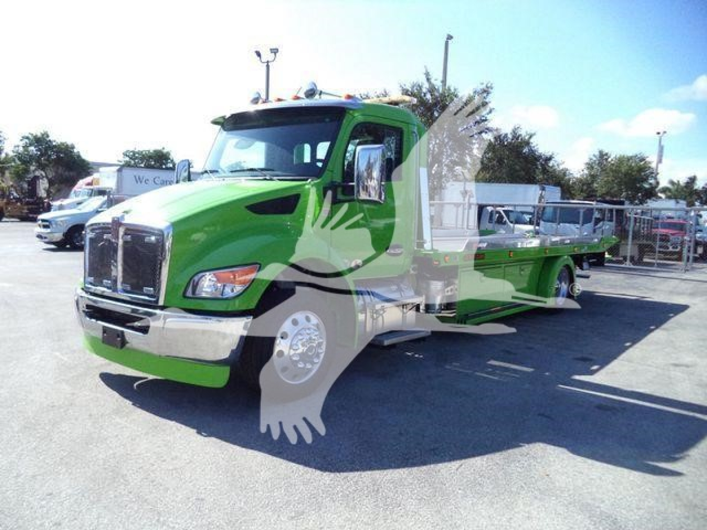 Kenworth T280 rollback truck in green with a light gray silhouette watermark, front grille, cab, and flatbed in view.