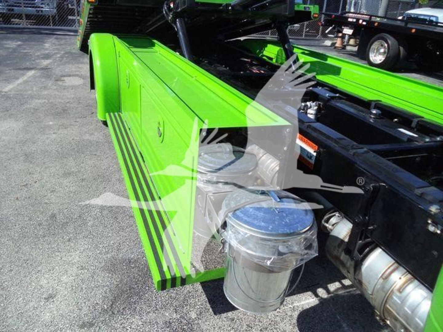Kenworth T280 rollback chassis showing bright lime green side panel with black pinstripe and chrome air filter housing, engine bay area visible.