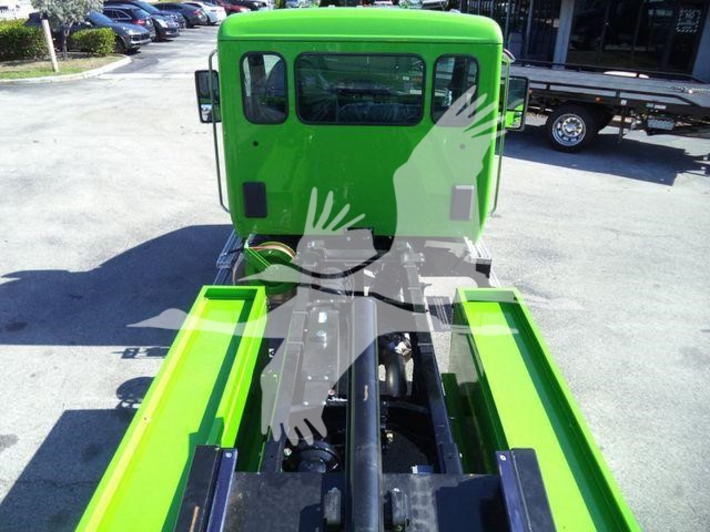 Green Kenworth T280 rollback truck cab from rear view showing chassis and hitch area