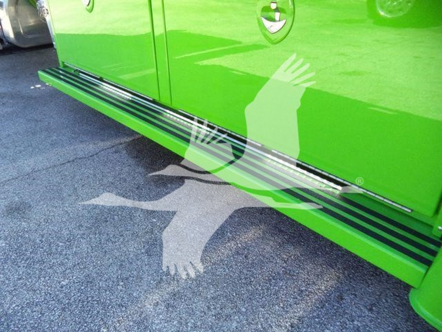 Kenworth T280 rollback truck side step chrome running boards along lower door area and bright green body with black accents.