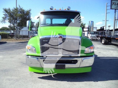 Kenworth T280 rollback truck front view, bright green cab with chrome bumper and grille, stock image overlapping watermark