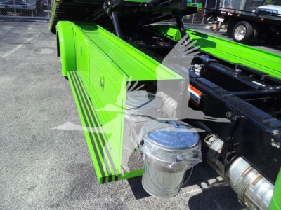Kenworth T280 rollback chassis showing bright lime green side panel with black pinstripe and chrome air filter housing, engine bay area visible.