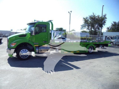 Green Kenworth T280 rollback tow truck side view showing extended flatbed and wheel lift.