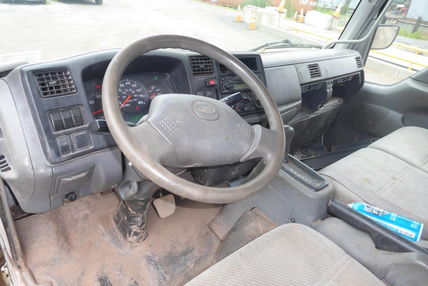 Truck interior showing steering wheel, dashboard, and center console of a 2006 Ford LCF cab and chassis.