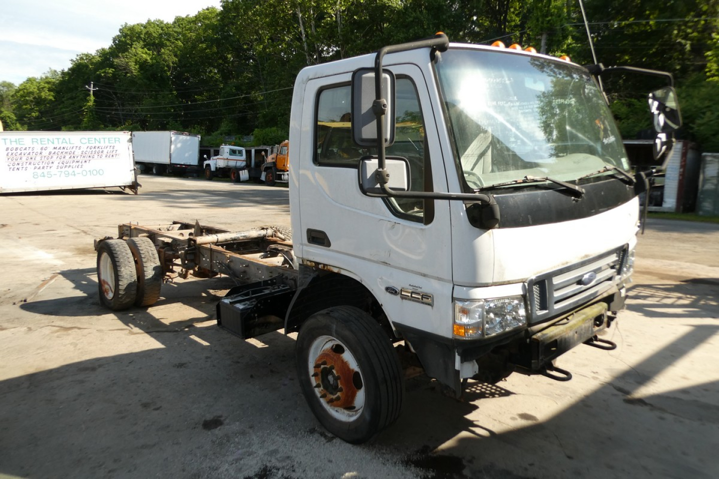 2006 Ford LCF cab and chassis truck front-left view with VIN plate and stock number visible on lot.