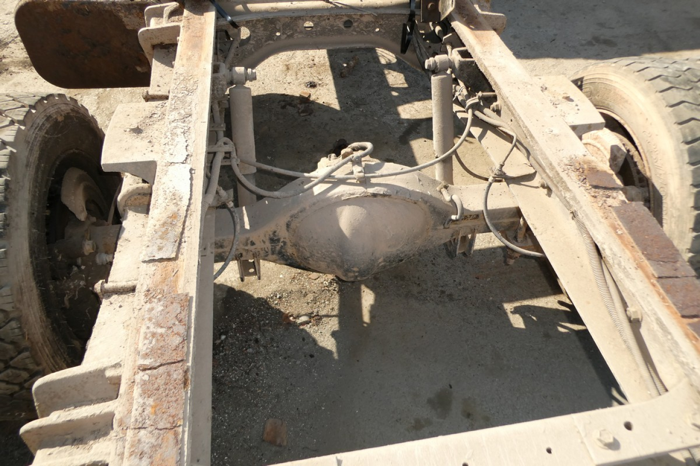 Rear view of Ford LCF chassis showing solid axle differential and frame rails with suspension components.