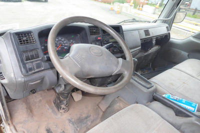 Truck interior showing steering wheel, dashboard, and center console of a 2006 Ford LCF cab and chassis.