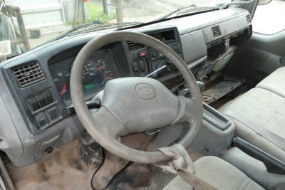 Ford LCF cab and chassis interior showing steering wheel, dashboard, and center console with faded controls.