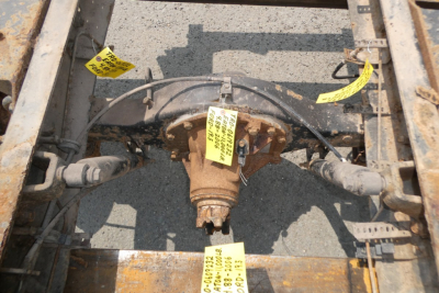 Ford LCF chassis rear-view showing differential and suspension components with yellow tags.