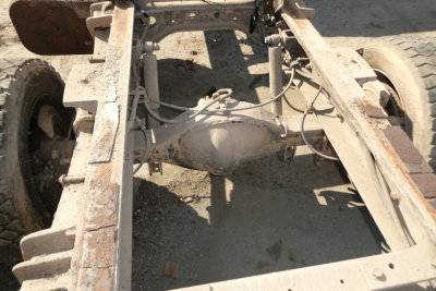 Rear view of Ford LCF chassis showing solid axle differential and frame rails with suspension components.