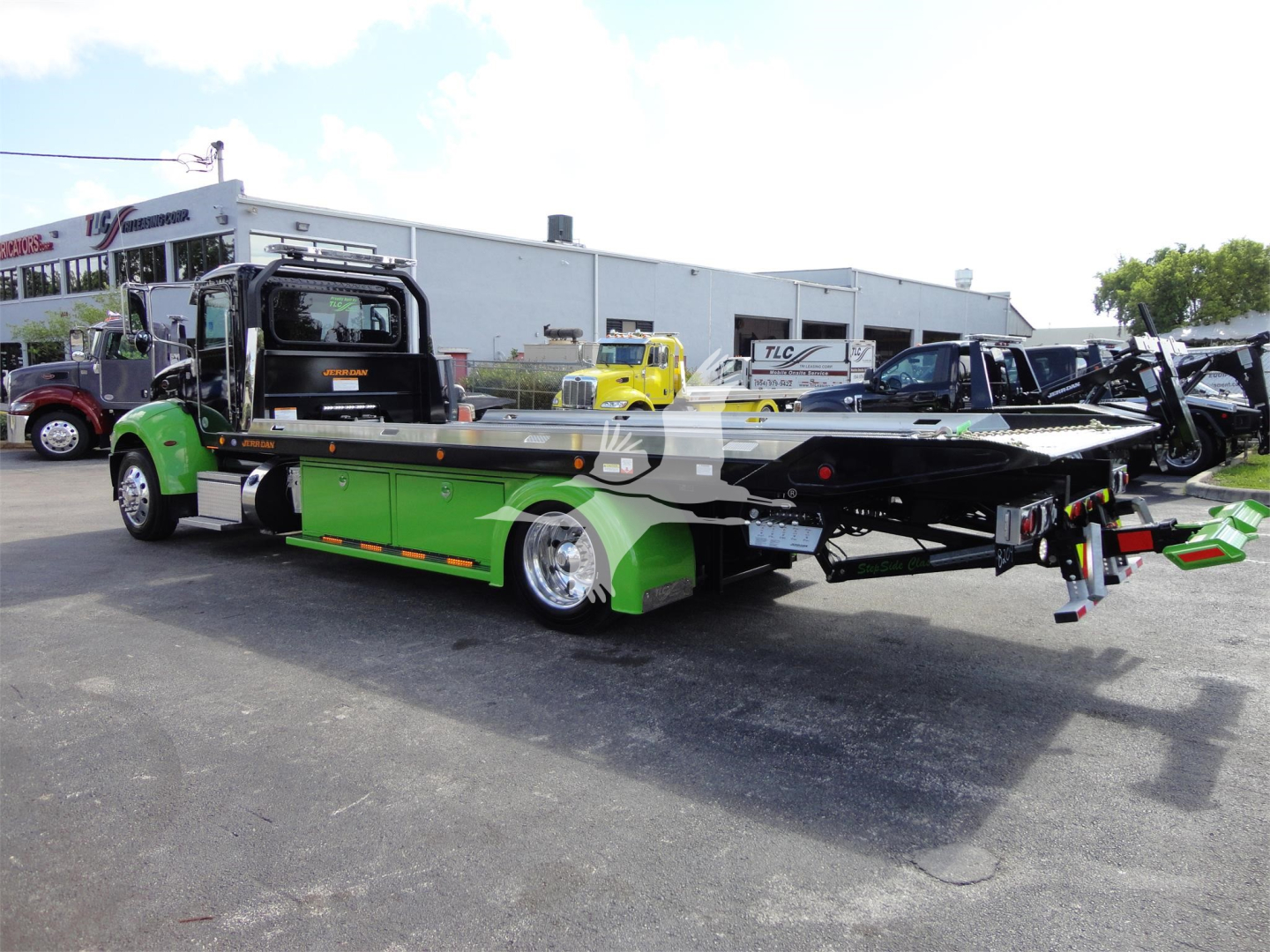 2022 Peterbilt 337 rollback tow truck in service with green undercarriage and black flatbed.