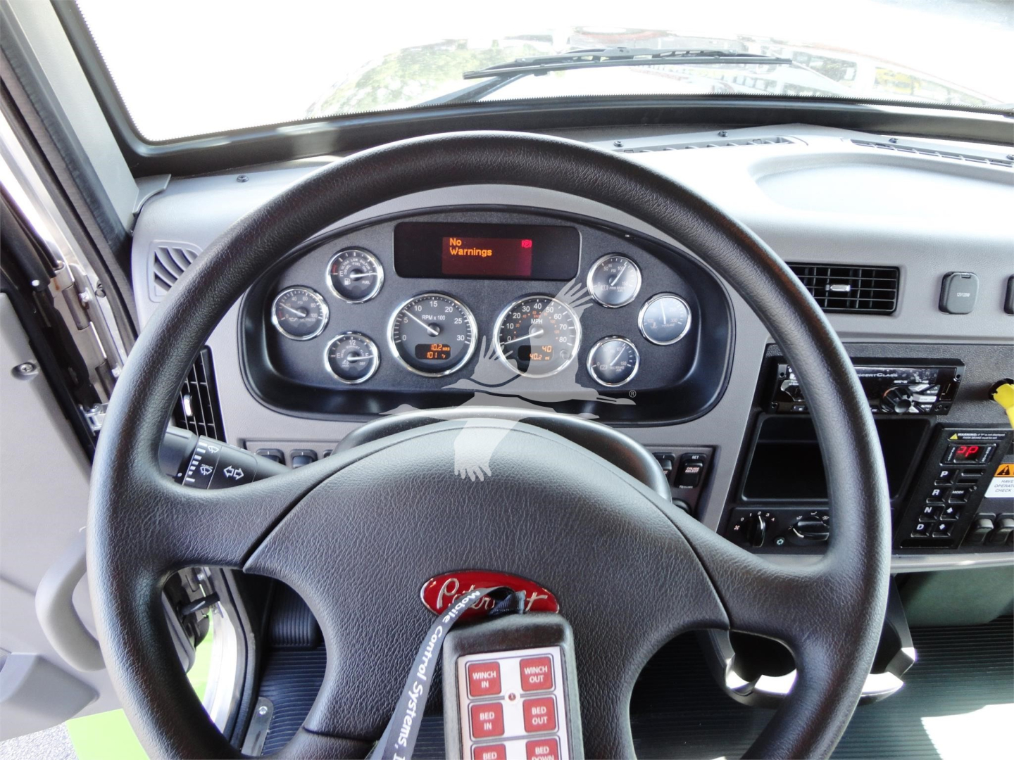 Peterbilt 337 cab dashboard and steering wheel with gauge cluster and digital display reading 'No Valley?' (text unclear) and various instrument dials.