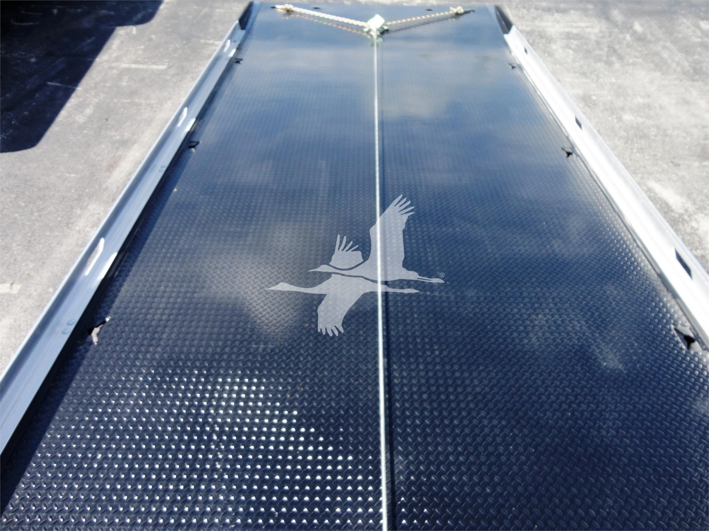 Flatbed? Diamond plate truck bed with Peterbilt logo showing overhead rails and tie-down points.
