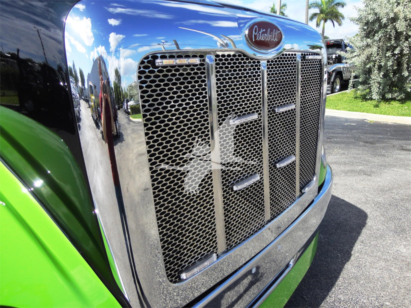 Peterbilt 337 front grille and chrome bumper in a close view showing the Peterbilt emblem.
