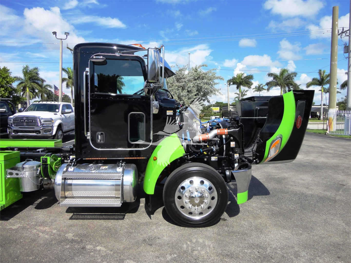 Peterbilt 337 cab with green accents showing engine bay and side view of suspension and fuel tank.