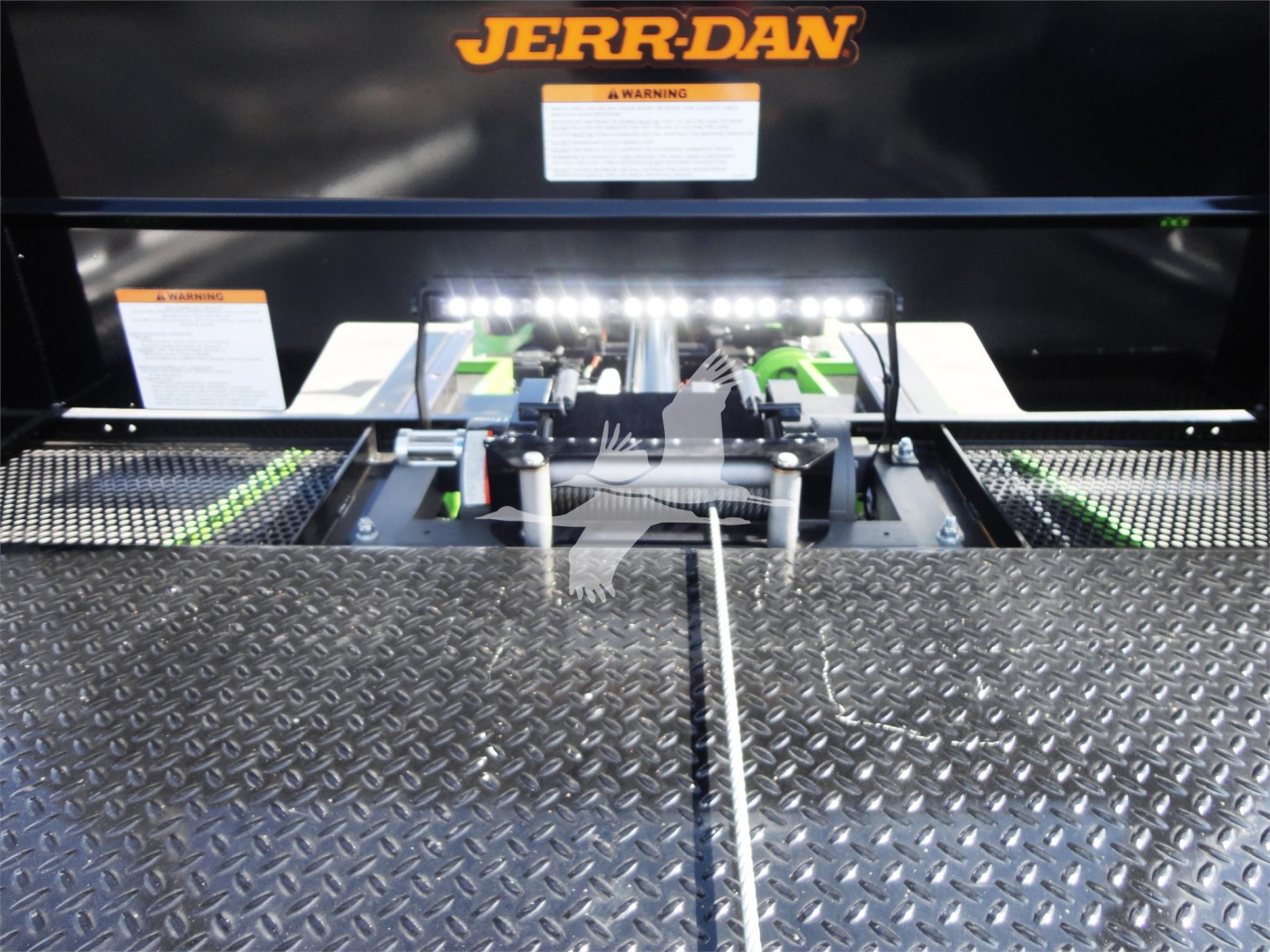 Peterbilt 337 rollback truck component area with Jerr-Dan branding and hydraulic hitch mechanism.