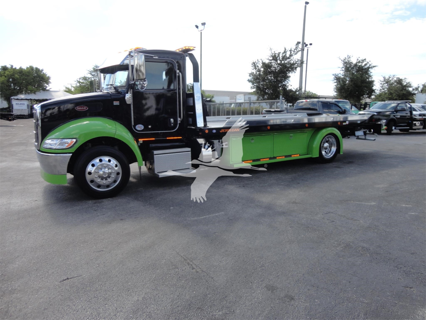 Peterbilt 337 rollback tow truck with green and black color scheme, stock number J56607 visible in listing context