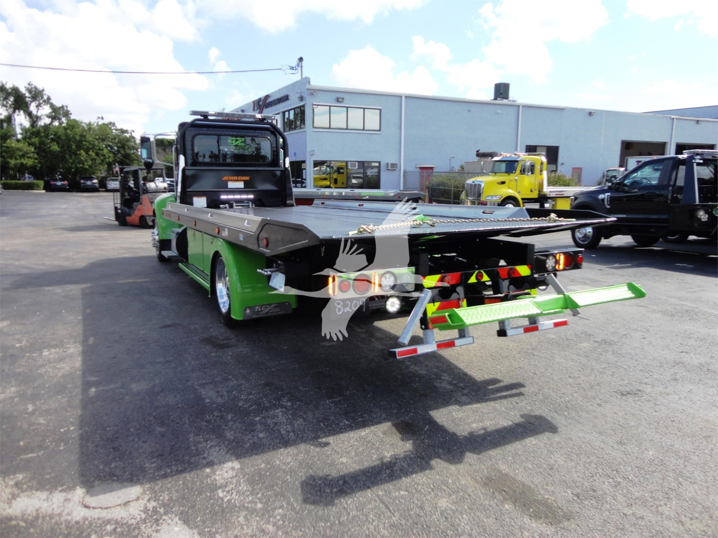 2022 Peterbilt 337 rollback truck rear view showing green accents and rear loading equipment