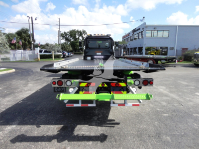 Truck rear view showing rollback bed and equipment connectors on Peterbilt 337.