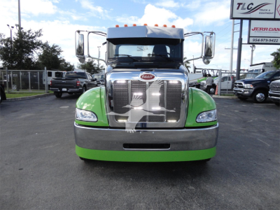 Peterbilt 337 truck front view with chrome grille, green lower bumper, and large mirrors.