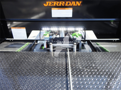 Peterbilt 337 rollback truck component area with Jerr-Dan branding and hydraulic hitch mechanism.